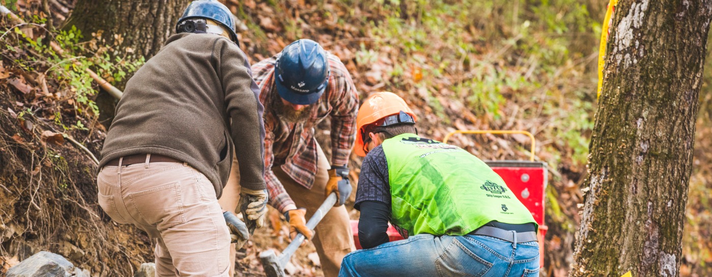 Three volunteers working on trail, funded by Shimano's Dig In program