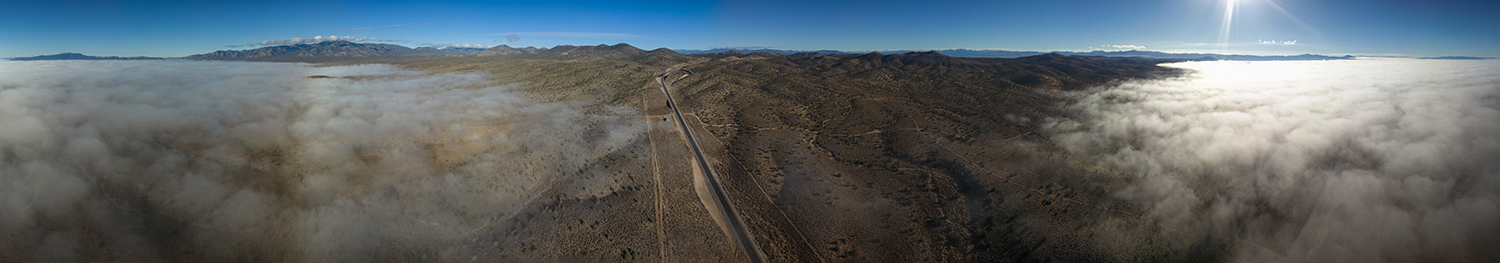 "Aerial photo overlooking the highway leading into Pioche, Nevada. A vast high desert environment with nothing for miles."