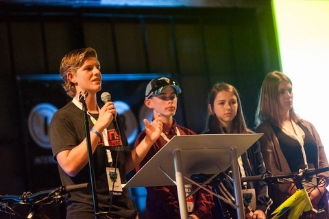 Youth advocates speaking in front of a large audience