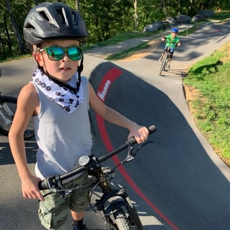 Rad little dude in bike park wearing imba bandana
