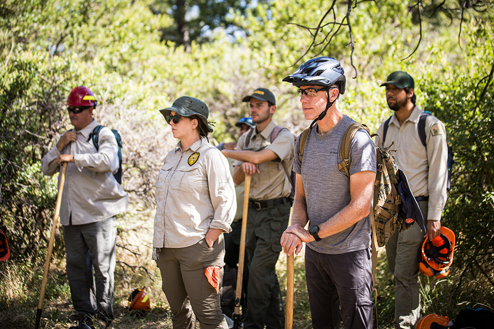 Volunteers and forest service employees gather before a trail work day.