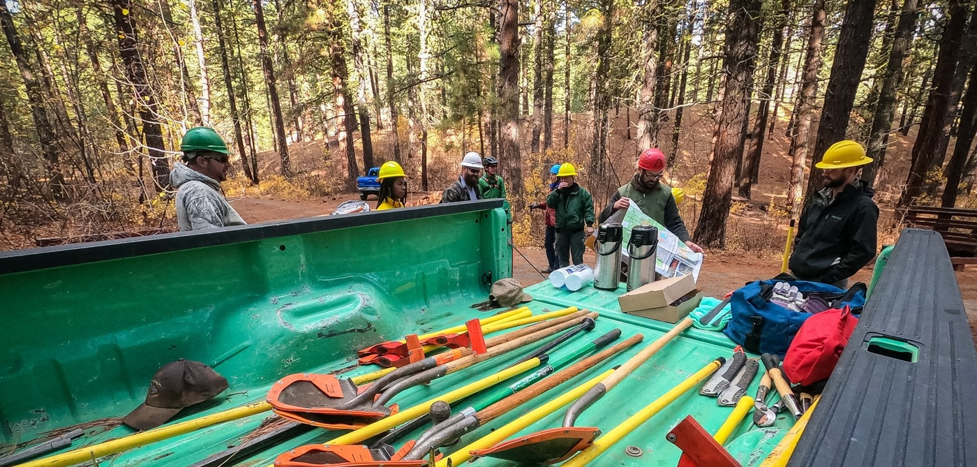 a trail crew gathers to discuss their plan