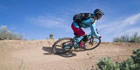 Mountain biker rides through a turn