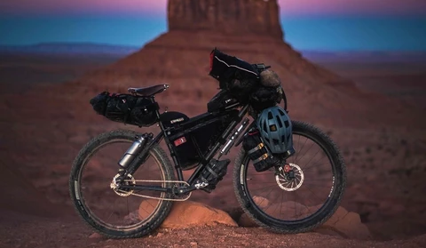 Bike loaded with packing gear, with desert background