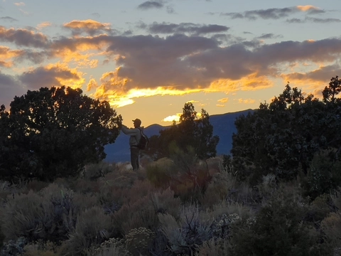 Joey Klein in silhouette designing trails in Pioche, NV.