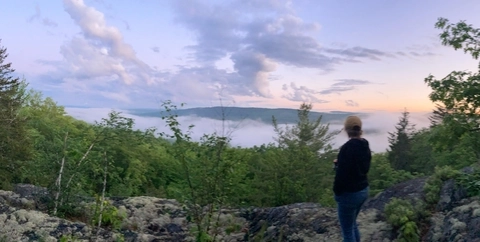 IMBA Trail Solutions Planner Liz Grades overlooks a ridge view in Monson, Maine.