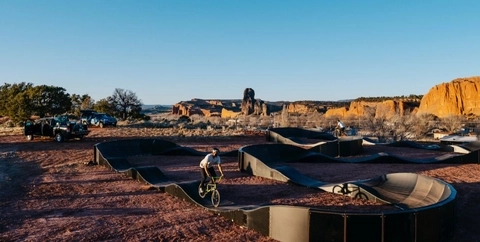 Two bikers test out new pump track installs in Navajo Township in the Navajo Nation.