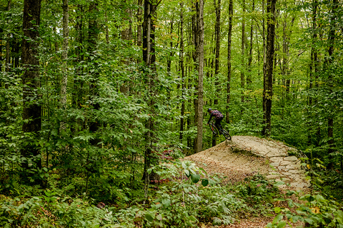 The author launches off a rock feature.