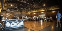 Large, beautiful room with IMBA banner showing the set up for the classroom portion of the IMBA Local Leadership Summit in Knoxville, TN.